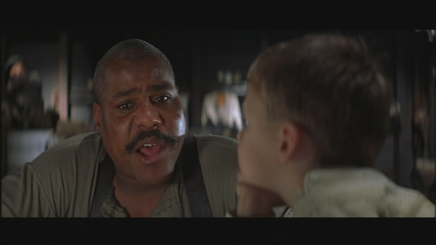 Danny (Bill Nunn) teaches words to a young 1900.