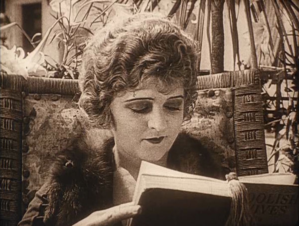 Check out the title of the book she's reading!